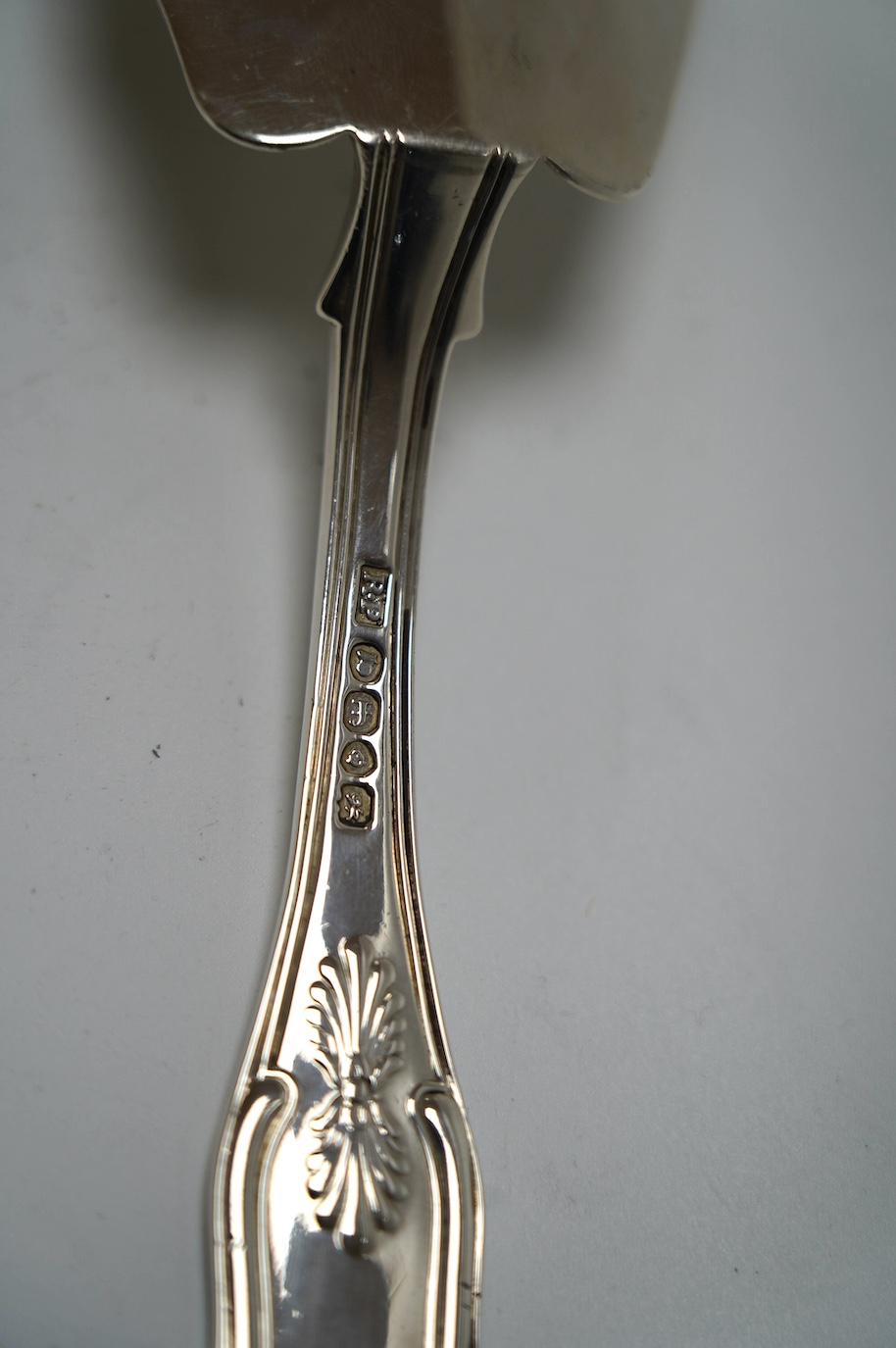 A George III silver fish slice with part gallery border, Henry Chawner, London, 1791, 30.4cm and a later George IV silver King's pattern fish slice, London, 1821. Condition - poor to fair